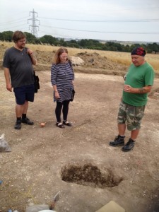 Keith points out pit on archaeological site
