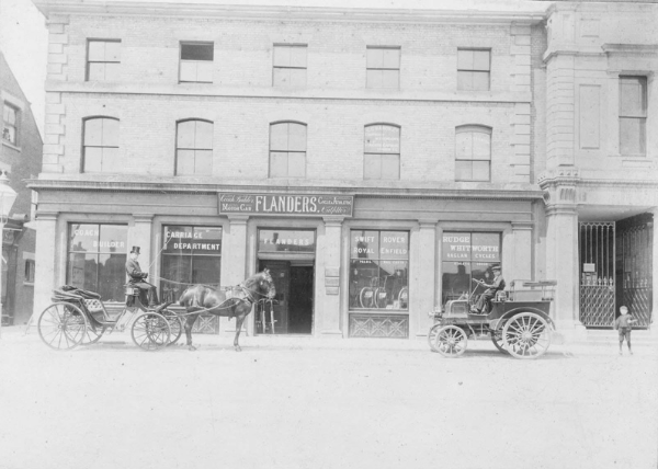 A horse drawn carriage and early motor car in Market Place about 1902